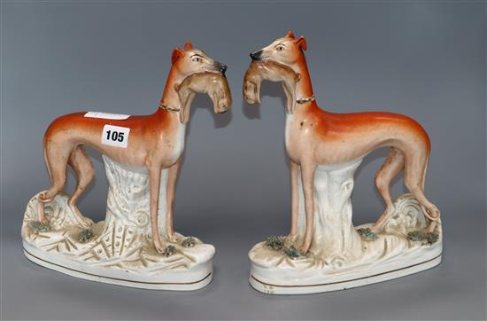 A pair of Victorian Staffordshire greyhound and hare groups height 28cm